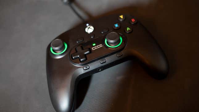 A Hori controller sits on a rubber mat. 