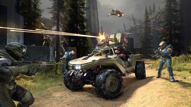Opposing Spartans face off in Halo Infinite. Several are in a Warthog vehicle, one is firing the machien gun mounted to it, while a few are on foot. A Banshee flies overhead in the background.